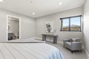 Carpeted bedroom featuring recessed lighting and ensuite bath