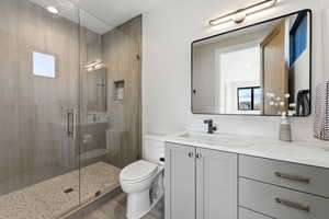 Bathroom featuring vanity and a shower stall