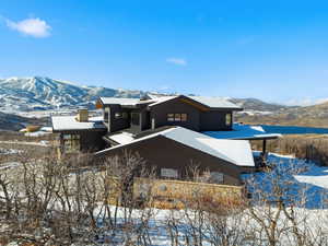 Snow covered house with a mountain view