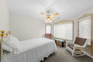 Bedroom with ceiling fan and carpet