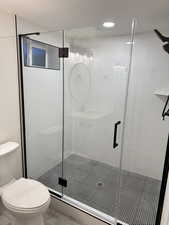 Full bathroom featuring a shower stall