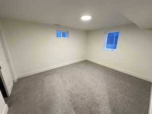 Finished basement with carpet flooring and baseboards