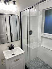 Bathroom with vanity and a shower stall