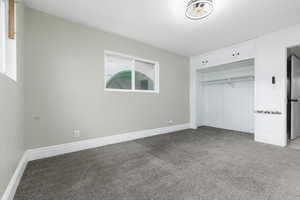 Unfurnished bedroom with light colored carpet and a closet