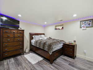 Bedroom featuring dark wood finished floors and recessed lighting