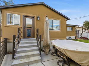 Doorway to property with stucco siding