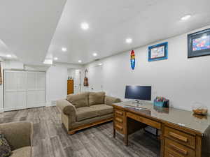 Office featuring light wood-style flooring and recessed lighting