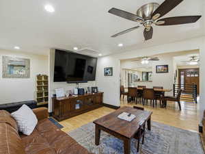 Living room featuring attic access, hardwood / wood-style floors, and recessed lighting