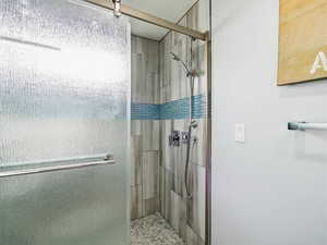 Full bath featuring a shower stall