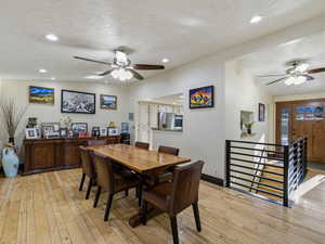 Dining area featuring ceiling fan, lofted ceiling, light wood-style flooring, and recessed lighting