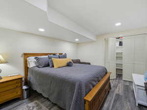 Bedroom featuring a closet, dark wood-style flooring, and recessed lighting