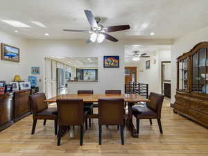 Dining area featuring light wood-style floors, recessed lighting, and ceiling fan