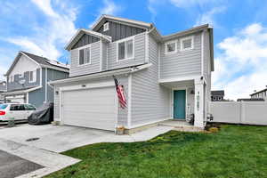 View of front of house featuring board and batten siding, an attached garage, and concrete driveway