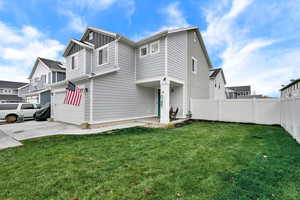 View of property exterior with board and batten siding, driveway, and a garage