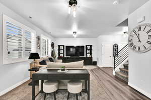 Living area featuring stairway and wood finished floors