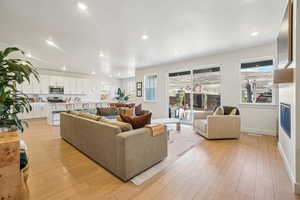 Living area featuring light wood-style flooring, recessed lighting, and a textured ceiling