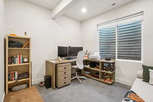 Office area with baseboards and light carpet