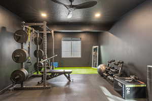 Workout room featuring rubber floors, ceiling fan, and recessed lighting
