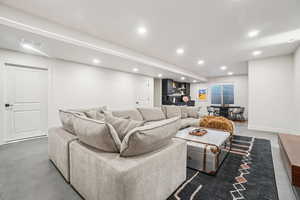 Living room featuring recessed lighting and concrete flooring