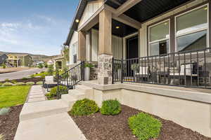 Property entrance with stone siding, a residential view, and a porch