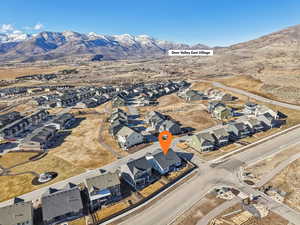 Aerial overview of property's location with nearby suburban area and mountains