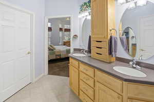 Ensuite master bathroom with double sinks, large shower, jetted tub, private water closet and huge master closet