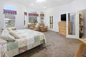 Large master bedroom with lots of natural light and door to deck