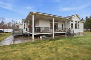 View of front of home with a front yard, roof with shingles, and covered porch