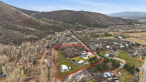 Aerial overview of property's location featuring property boundaries highlighted and a mountainous background