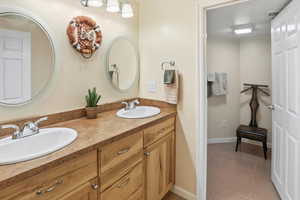 Full Bathroom featuring double vanity and light tile patterned floors - door for separation between toilet and shower/tub area