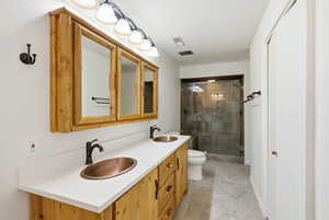 Full bathroom with a stall shower and double vanity