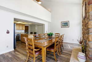 Dining room featuring dark wood-style floors and baseboards