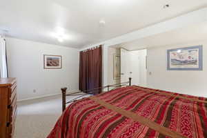 Carpeted bedroom with baseboards