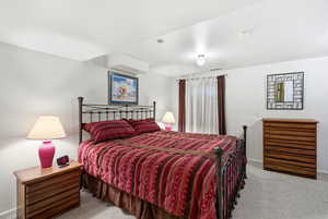 Carpeted bedroom featuring baseboards