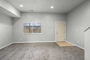 Spare room with light colored carpet and recessed lighting