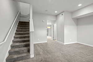 Staircase featuring carpet floors and recessed lighting