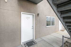 Entrance to property featuring stucco siding and a patio