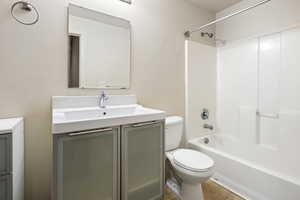 Bathroom with tub / shower combination, vanity, and light tile patterned floors