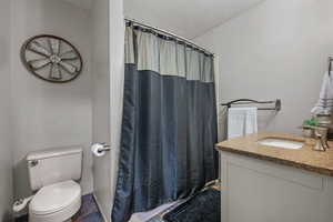 Bathroom with curtained shower and vanity