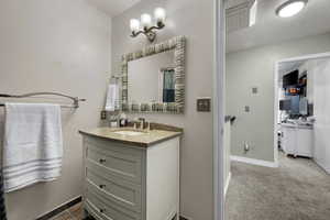 Full bath with vanity, a shower with curtain, and dark carpet