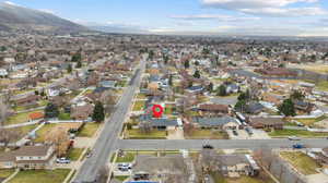 Aerial view of property and surrounding area featuring nearby suburban area