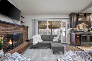Living room with a fireplace and light wood finished floors