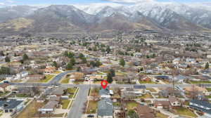 Aerial view of property's location with nearby suburban area and a mountain backdrop