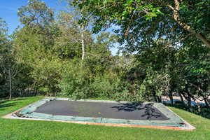 View of pool featuring a lawn