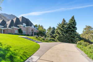View of front facade featuring a front yard and brick siding