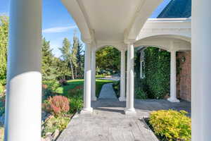 Covered porch featuring a lawn