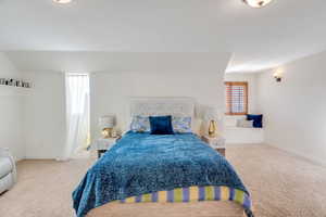 Bedroom featuring light colored carpet