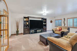 Living area with light colored carpet and baseboards