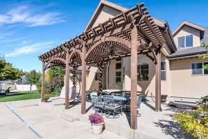 View of patio featuring a pergola and outdoor dining area