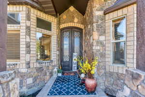 Property entrance featuring stone siding